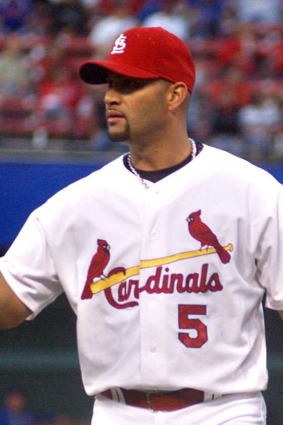 Albert Pujols in a red St. Louis Cardinals cap and white No. 5 Cardinals home uniform on the field at Busch Stadium, 2008