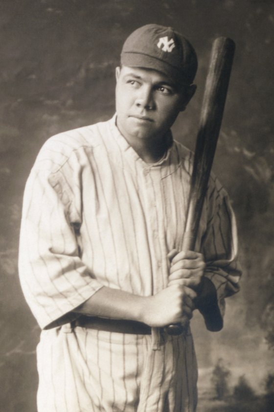 Babe Ruth in a pinstriped New York Yankees uniform, holding a bat on his shoulder, 1920