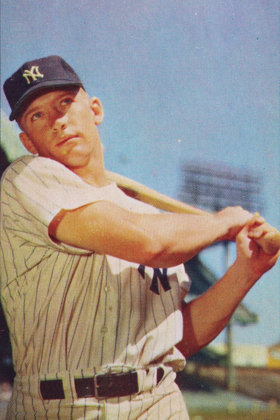 Mickey Mantle in a pinstriped New York Yankees uniform, following through on a swing, on his 1953 Bowman Color baseball card